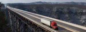 Semi Truck Driving Over Bridge