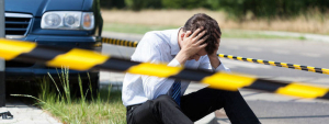 Guy Sitting on Ground After Car Accident